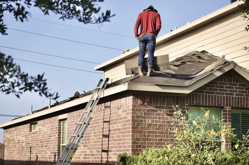 Professional roofer working on a residential roof in Lowes Island